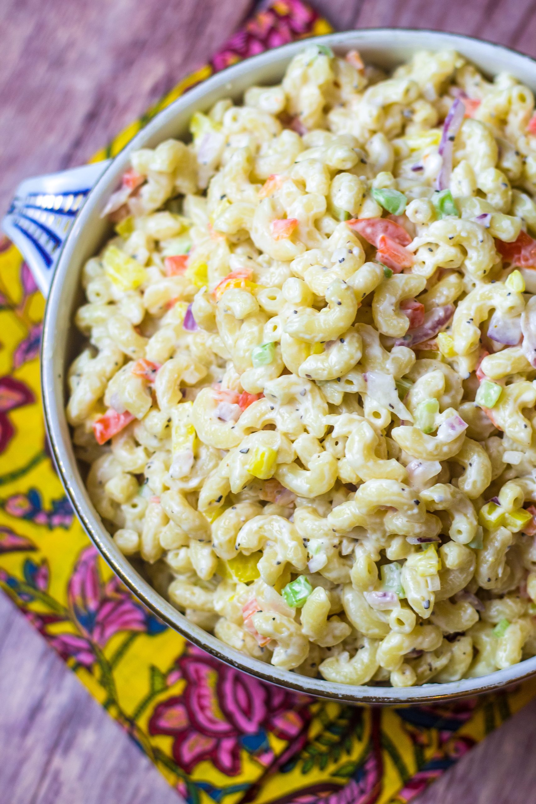 This southern macaroni salad is the perfect summer side dish. It's creamy, sweet, and the best accompaniment to your barbeque or cookout. All you'll have to do is boil your noodles, chop your veggies then literally mix all of your ingredients together. It's that simple. Plus, it will keep in the fridge for a couple of days, so it's a great make-ahead dish. Read along to see how to make southern macaroni salad in no time.
