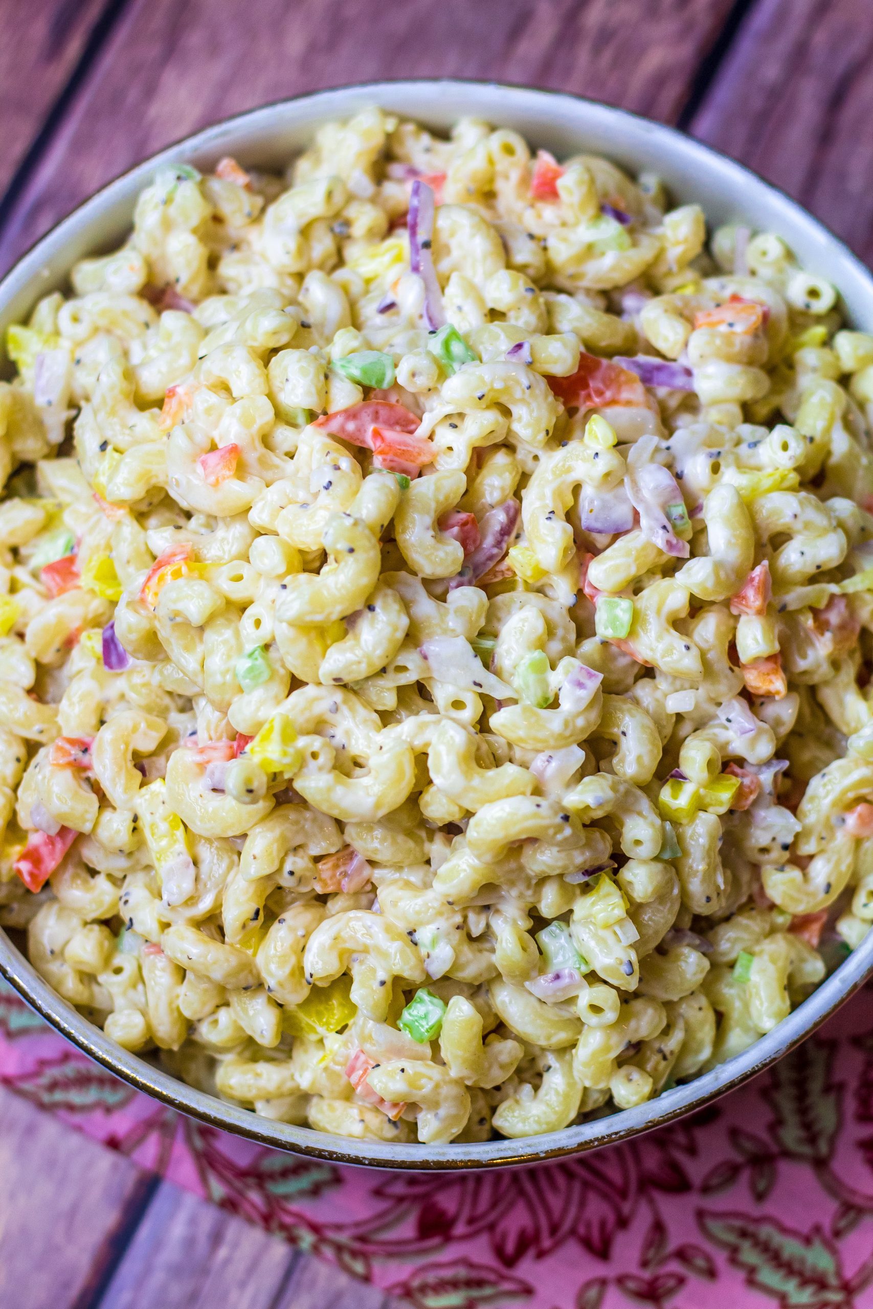 This southern macaroni salad is the perfect summer side dish. It's creamy, sweet, and the best accompaniment to your barbeque or cookout. All you'll have to do is boil your noodles, chop your veggies then literally mix all of your ingredients together. It's that simple. Plus, it will keep in the fridge for a couple of days, so it's a great make-ahead dish. Read along to see how to make southern macaroni salad in no time.