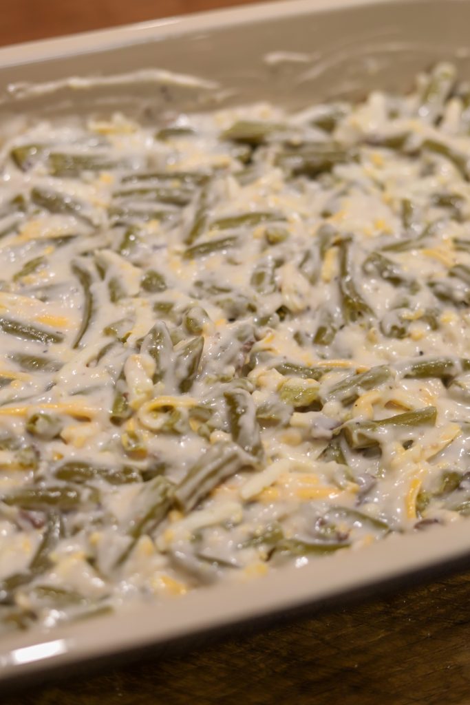 Enjoy a twist on the classic with this Cheesy Green Bean Casserole, perfect for any gathering with its savory cheese and rich ingredients.