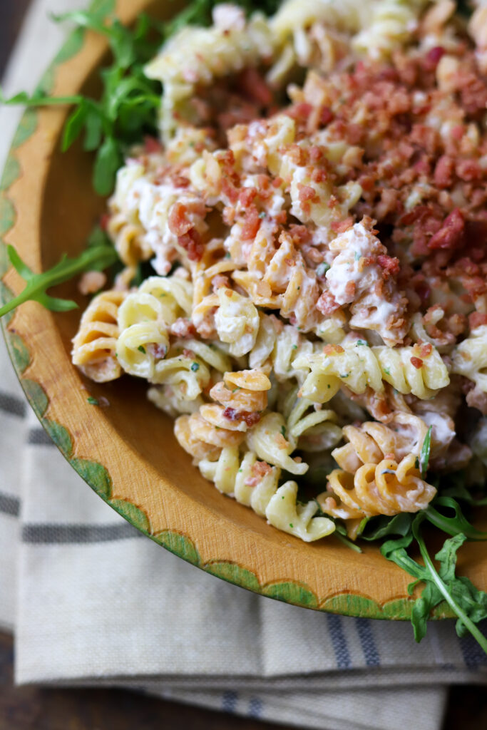 This bacon ranch pasta salad is my favorite food to always have on hand in my refrigerator. I'm telling y'all...this pasta salad is so good and keeps so well. It's a simple mix of pasta, mayo, sour cream, real bacon bits and a packet of ranch dip mix. This is perfect to serve as a lunch or a dish for a function.
