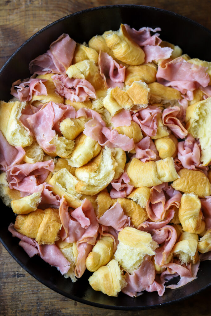 Ham and Swiss Croissant Breakfast Casserole: Savory Honey Ham, flakey croissants, sweet Swiss cheese all in one delicious, eggy bite!