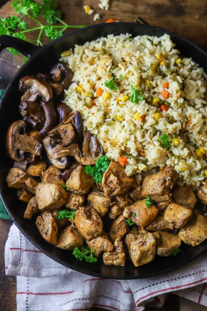 Ok. This cast iron skillet chicken breast bites with mushrooms and veggie rice recipe. The perfect simple, and quick dinner. These are just some simple cast iron skillet chicken breasts cut into cubes then sauteed with some seasonings, soy and Worcestershire sauce. Do the same with the mushroom and all the while be cooking your rice with a can of veg-all and chicken broth. Add it all back to the skillet and let the rice soak up that mushroom and chicken flavor. This recipe is so good and takes less than thirty minutes to make.