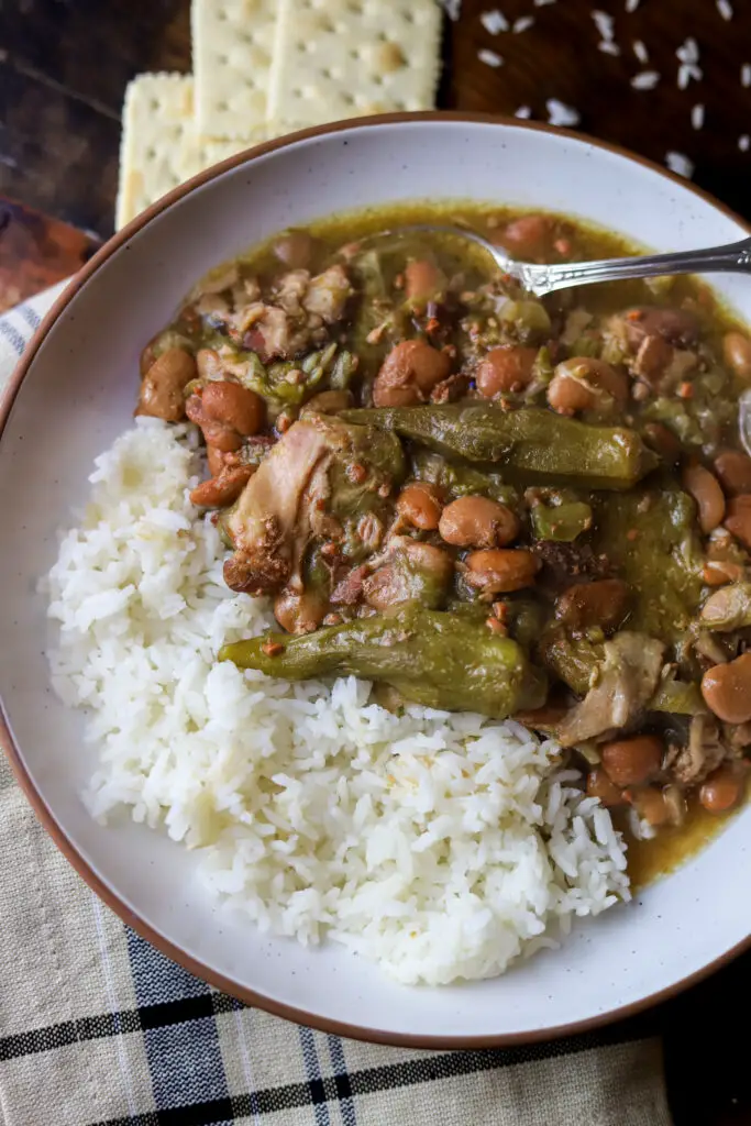 This crockpot speckled butter beans and okra stew is a classic dish that's super easy. You'll take some frozen butter beans and okra and dump them into a crockpot on low heat with some seasonings, veggies and bacon. Takes less than 5 minutes to put together. Let it slow cook for 5 hours for the easiest down-home meal.