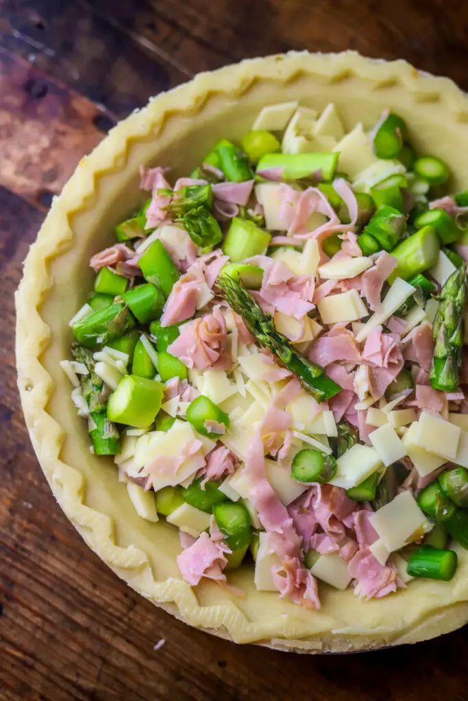 This Swiss, ham and asparagus quiche. It's the perfect brunchy food for spring. All the flavors pair so well together and it's super easy to make. I used a storebought pie crust then filled it to the brim with fresh asparagus, honey ham and Swiss cheese. Then, I beat an egg mixture and poured over the top. Baked and there you have it! It's super easy and can be served at so many types of occasions.