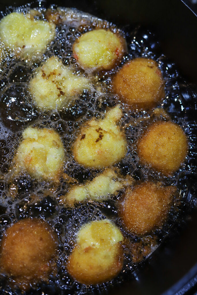 I love these sweet Jiffy hush puppies. The honey Jiffy cornbread mix makes for the sweetest, yet most savory bite. These are homemade and seriously really simple to make. Mix all your ingredients in a bowl and drop them in to hot grease for about 3 to 4 minutes each. They'll be so golden and crispy. Serve these with butter or honey for the perfect bite!