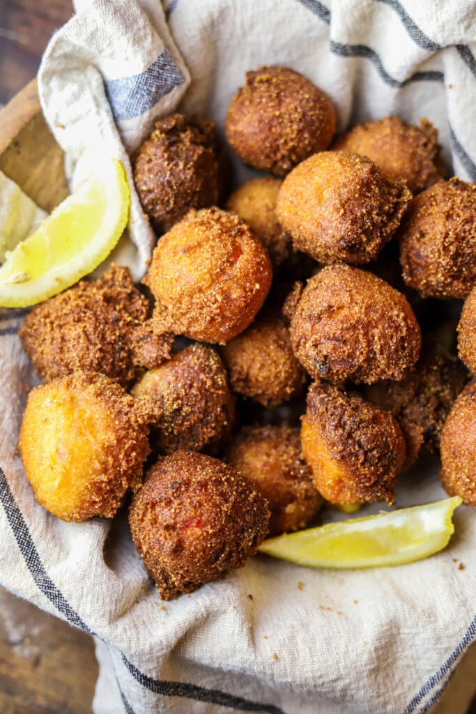 I love these sweet Jiffy hush puppies. The honey Jiffy cornbread mix makes for the sweetest, yet most savory bite. These are homemade and seriously really simple to make. Mix all your ingredients in a bowl and drop them in to hot grease for about 3 to 4 minutes each. They'll be so golden and crispy. Serve these with butter or honey for the perfect bite!