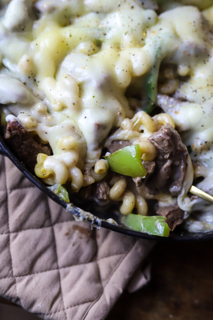 This philly cheesesteak pasta skillet is a perfect simple weeknight meal. Its bits of beef sauteed with bell peppers and onion then folded in with pasta and a cream of mushroom sauce. Then top it off with some provolone cheese and broil it until its nice and melted and bubbly. This one pot meal is perfect to make for a quick dinner.