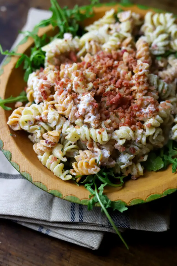 This bacon ranch pasta salad is my favorite food to always have on hand in my refrigerator. I'm telling y'all...this pasta salad is so good and keeps so well. It's a simple mix of pasta, mayo, sour cream, real bacon bits and a packet of ranch dip mix. This is perfect to serve as a lunch or a dish for a function.