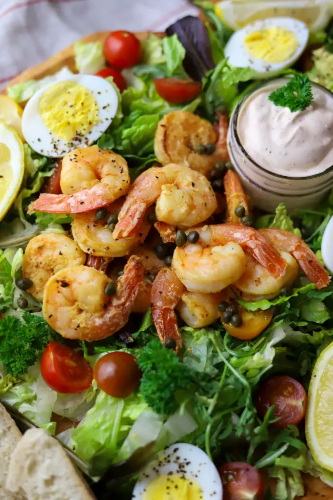This shrimp louie salad is the perfect salad to make a meal of. It's so rich and hearty with some skillet sauteed shrimp, boiled eggs, avocado and creamy homemade dressing.
