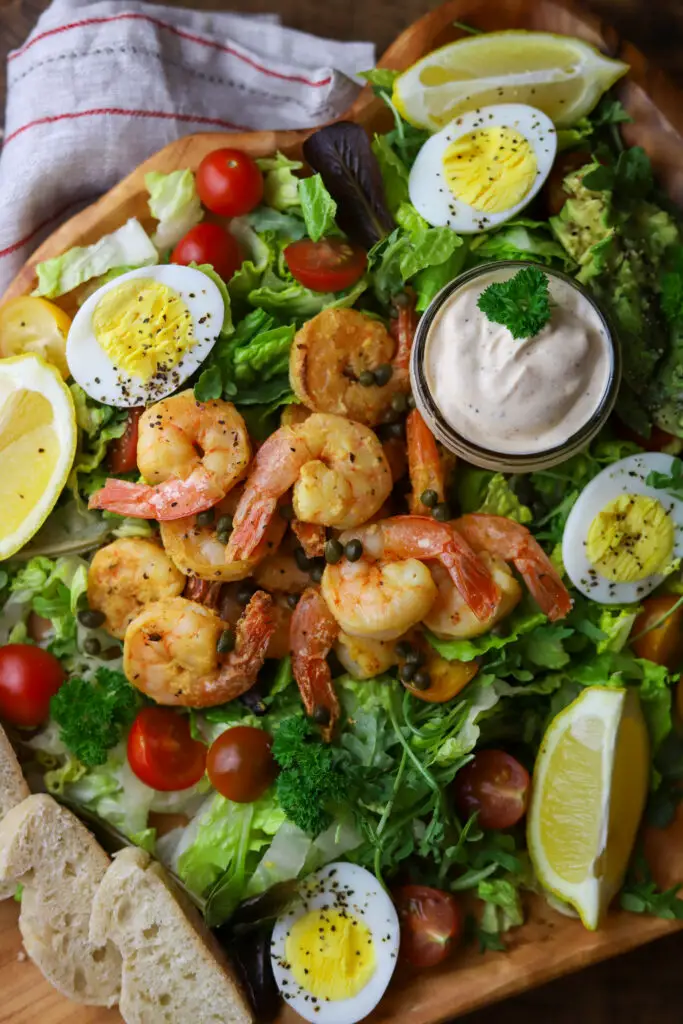 This shrimp louie salad is the perfect salad to make a meal of. It's so rich and hearty with some skillet sauteed shrimp, boiled eggs, avocado and creamy homemade dressing.