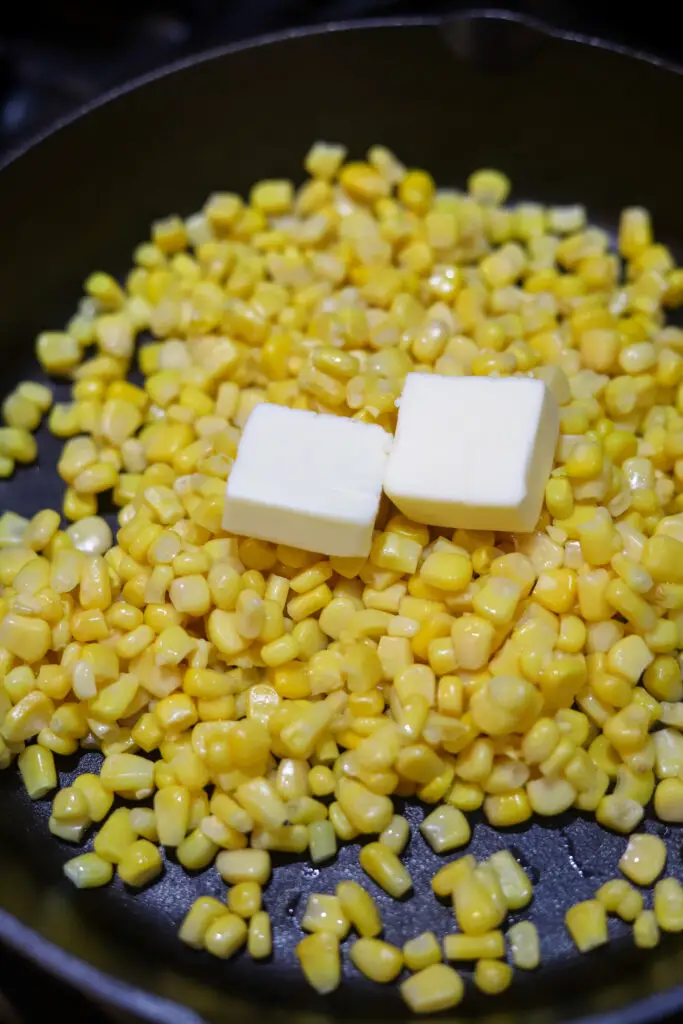 This country skillet cream corn. It just reminds me of my Granny's house. This is her recipe and I actually texted her for the exact details! It's the perfect combo of savory and sweet. It's super simple, but she said the frozen pouch of cream corn is essential. You'll love this skillet corn recipe. It's what I grew up on.
