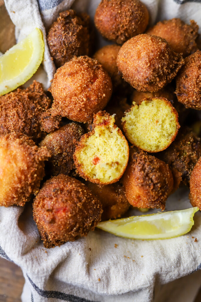 I love these sweet Jiffy hush puppies. The honey Jiffy cornbread mix makes for the sweetest, yet most savory bite. These are homemade and seriously really simple to make. Mix all your ingredients in a bowl and drop them in to hot grease for about 3 to 4 minutes each. They'll be so golden and crispy. Serve these with butter or honey for the perfect bite!