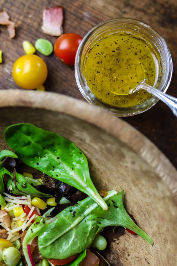 This corn succotash salad is perfect for a meal or for a side. It's packed with fresh greens, corn, baby lima beans, pimentos and bacon. Top it with a homemade sweet onion dressing to finish. This salad just screams Southern comfort thrown into a fresh and light salad.