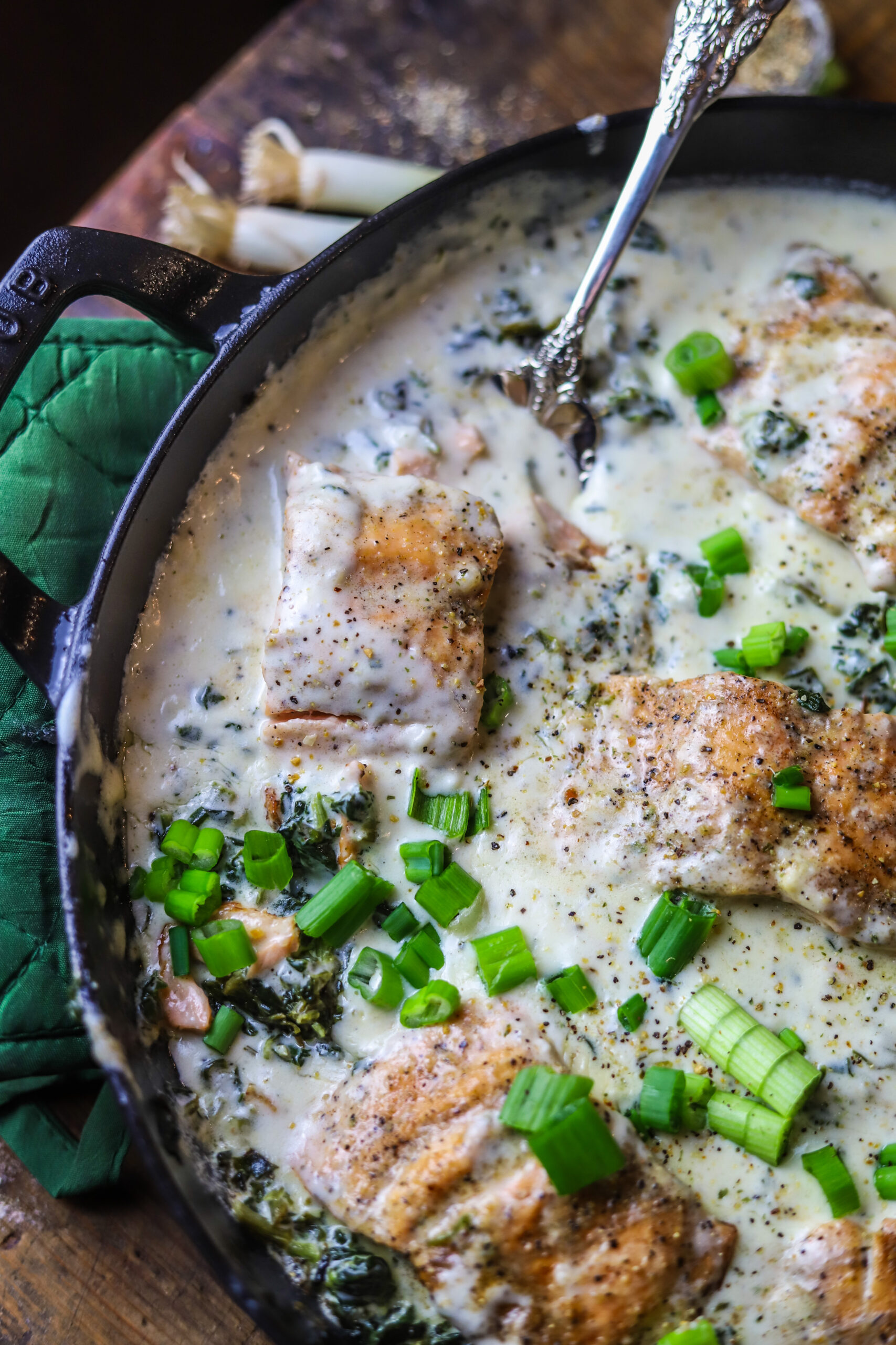 This salmon and spinach skillet with Boursin cheese is the most decadent one-pot dinner idea. It's pan-seared salmon with frozen spinach and a creamy rich Boursin cream sauce poured over the top then simmer covered to bring it all together. This meal looks super sophisticated, but it's really so simple and so delicious.