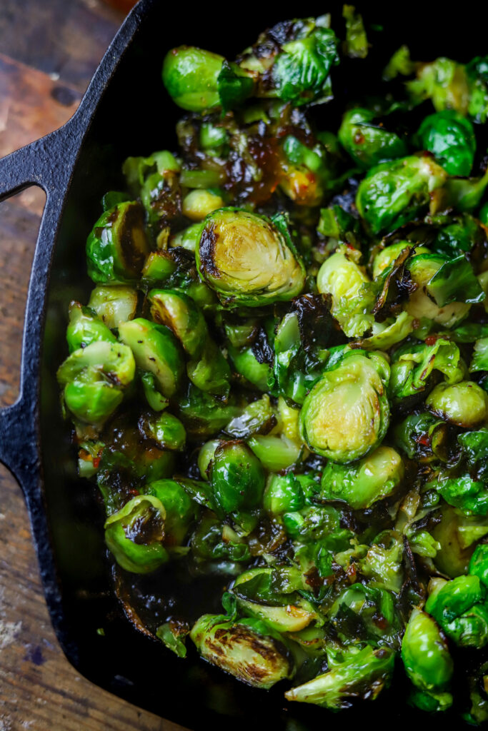 These pepper jelly caramelized brussel sprouts have become a favorite around here. They only require two ingredients along with some salt and pepper and that's it. You'll sauté the brussel sprouts in cast iron, then remove from heat and stir in some spicy pepper jelly. Taking less than 10 minutes to make, you seriously can't beat them. Plus, they are amazingly delicious.