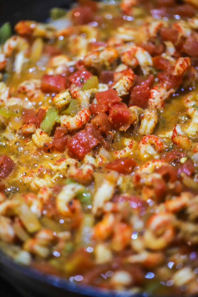 This Cajun creamy orzo recipe. It's so delicious. It's a spicy tomato base with crawfish tails. Add your orzo with some broth and let it all cook until your pasta is nice and tender. Fold in heavy cream, parmesan and browned smoked sausage. This one-pot meal is so simple and delicious and takes less than 30 to make. 