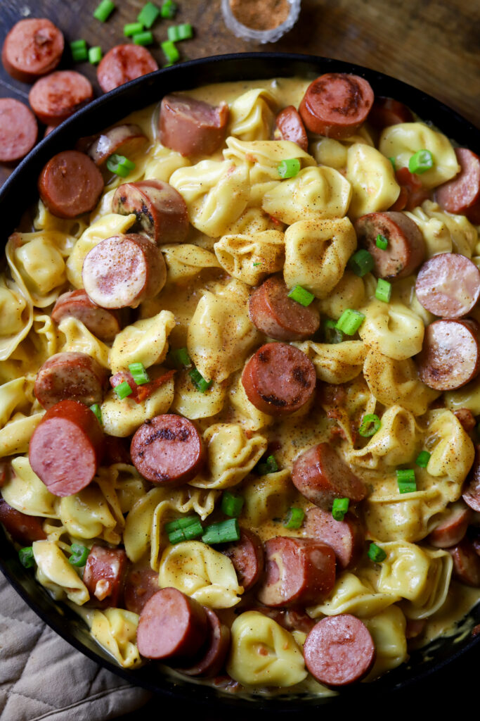 This Cajun sausage and cheese tortellini skillet is the perfect quick dinner. All you’re gonna do is boil some cheese tortellini and brown some smoked sausage. Remove it from the skillet and whisk up a cheesy spicy Cajun sauce. Toss them all back into the same skillet if you have the perfect one pot meal. 