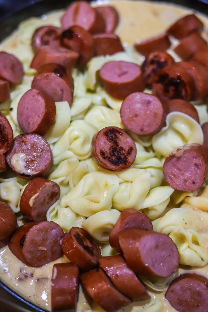 This Cajun sausage and cheese tortellini skillet is the perfect quick dinner. All you’re gonna do is boil some cheese tortellini and brown some smoked sausage. Remove it from the skillet and whisk up a cheesy spicy Cajun sauce. Toss them all back into the same skillet if you have the perfect one pot meal. 