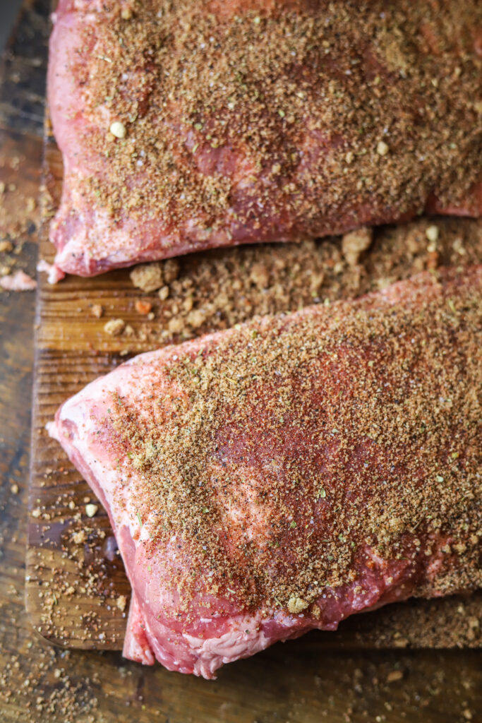 These slow cooker pork spare ribs with this homemade rib rub. You won't want to make ribs any other way. It's so simple, and you practically only need two ingredients, plus your seasonings. Mix your rub together, rub it on the ribs, add them and a can of coke to the crockpot and slow cook for 6 hours. These make the simplest and juiciest ribs for your next cookout or summer event. 