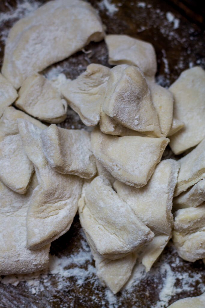 These chicken and dumplings with biscuits is seriously the best chicken and dumplings recipe ever. Hands down. You'll start with a broth base with some chicken, onions and celery. Drop in some cut up canned biscuits. Then, add in some milk, heavy cream, and...white country gravy mix. Yes, it's literally the last southern chicken and dumplings recipe you'll ever want or need and it's so simple to make.