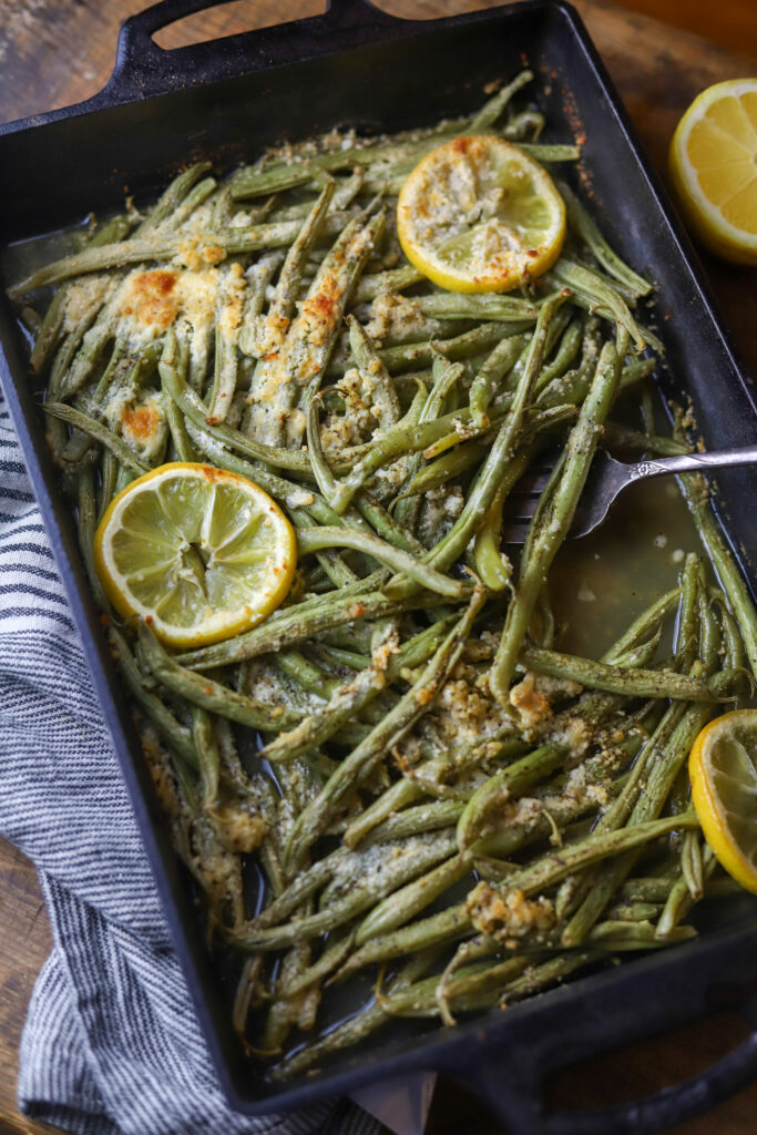 These lemon parmesan green beans are the best side vegetable. They are fresh green beans topped with garlic, butter, lemon, and grated parmesan cheese. Just dump them all in a dish and bake for about 20-25 minutes. So simple and the best side dish. 