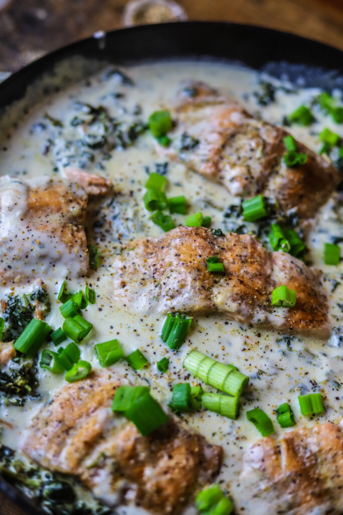 This salmon and spinach skillet with Boursin cheese is the most decadent one-pot dinner idea. It's pan-seared salmon with frozen spinach and a creamy rich Boursin cream sauce poured over the top then simmer covered to bring it all together. This meal looks super sophisticated, but it's really so simple and so delicious.