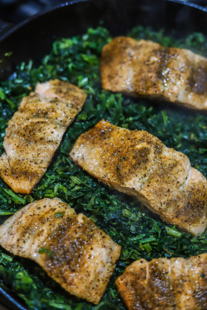 This salmon and spinach skillet with Boursin cheese is the most decadent one-pot dinner idea. It's pan-seared salmon with frozen spinach and a creamy rich Boursin cream sauce poured over the top then simmer covered to bring it all together. This meal looks super sophisticated, but it's really so simple and so delicious.