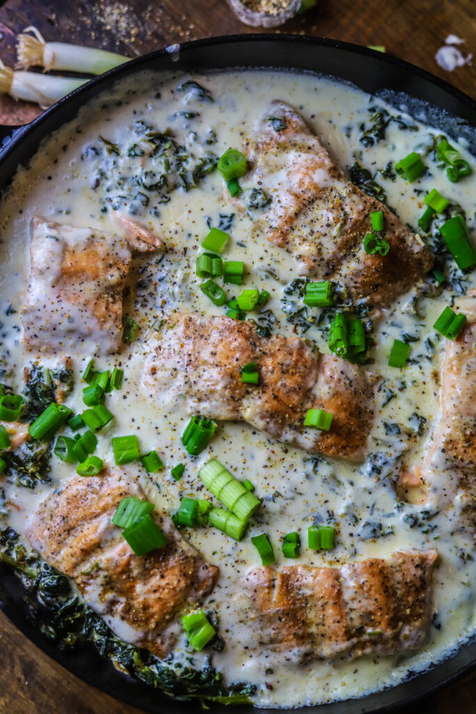 This salmon and spinach skillet with Boursin cheese is the most decadent one-pot dinner idea. It's pan-seared salmon with frozen spinach and a creamy rich Boursin cream sauce poured over the top then simmer covered to bring it all together. This meal looks super sophisticated, but it's really so simple and so delicious.