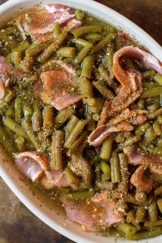 I love these southern green beans. This is such an easy side dish recipe that takes no time to make. It's canned green beans with some bacon, brown sugar, butter and spices. Bake for about 25 minutes until the bacon is cooked and all the flavors come together. You can't beat this southern green beans recipe.