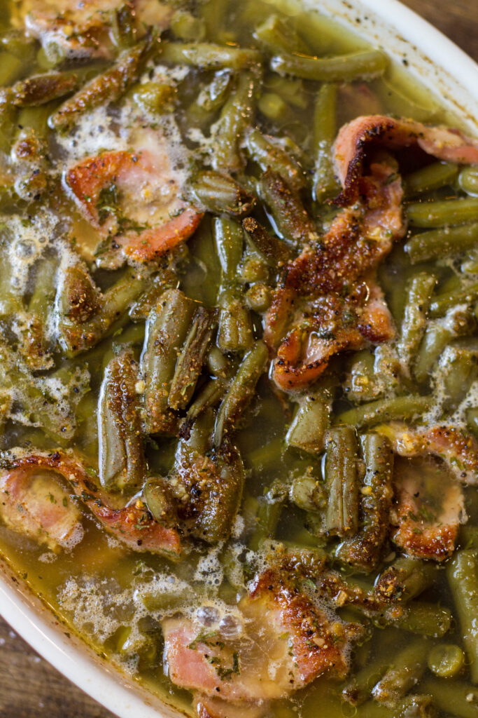 I love these southern green beans. This is such an easy side dish recipe that takes no time to make. It's canned green beans with some bacon, brown sugar, butter and spices. Bake for about 25 minutes until the bacon is cooked and all the flavors come together. You can't beat this southern green beans recipe.