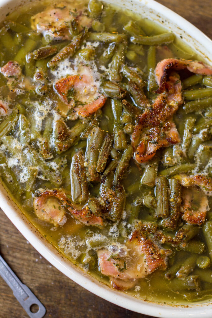 I love these southern green beans. This is such an easy side dish recipe that takes no time to make. It's canned green beans with some bacon, brown sugar, butter and spices. Bake for about 25 minutes until the bacon is cooked and all the flavors come together. You can't beat this southern green beans recipe.