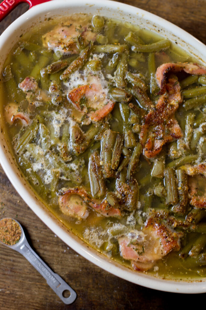 I love these southern green beans. This is such an easy side dish recipe that takes no time to make. It's canned green beans with some bacon, brown sugar, butter and spices. Bake for about 25 minutes until the bacon is cooked and all the flavors come together. You can't beat this southern green beans recipe.