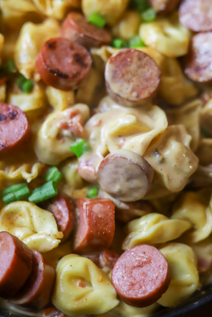 This Cajun sausage and cheese tortellini skillet is the perfect quick dinner. All you’re gonna do is boil some cheese tortellini and brown some smoked sausage. Remove it from the skillet and whisk up a cheesy spicy Cajun sauce. Toss them all back into the same skillet if you have the perfect one pot meal. 