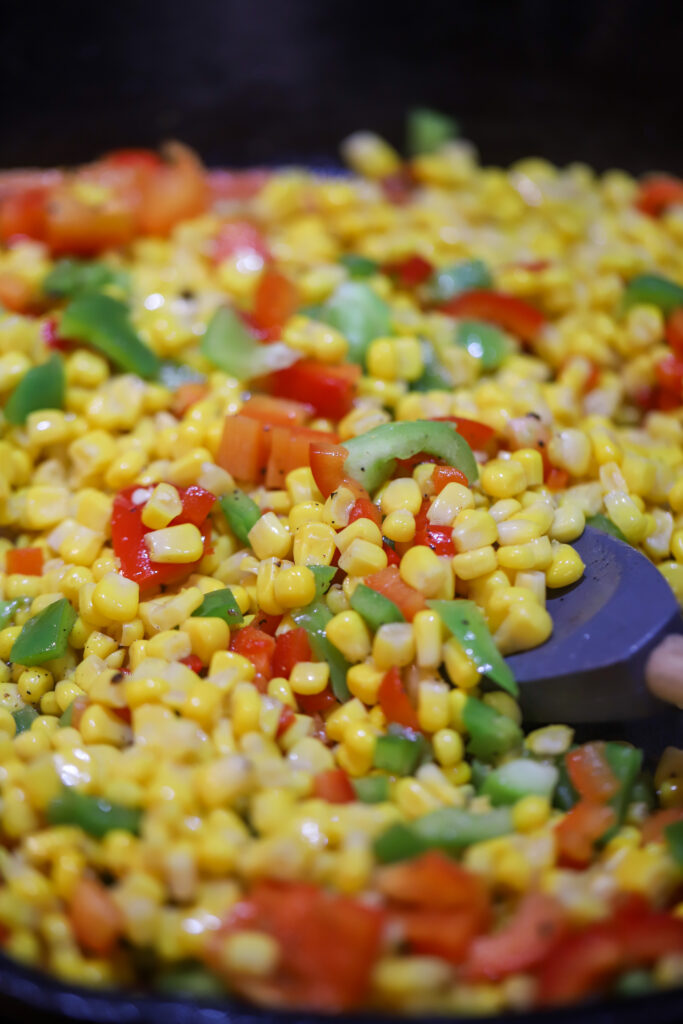 This one pot pork chop maque choux. Maque choux is a traditional, southern corn dish with peppers and ham or bacon. This one pot recipe combines it all with a pan fried, bone-in pork chop, on top a of corn, bell pepper, and bacon mixture. Add a cream of celery to give it a gravy feel then serve it all over rice or mashed potatoes. This recipe is so simple and perfect for dinner. 