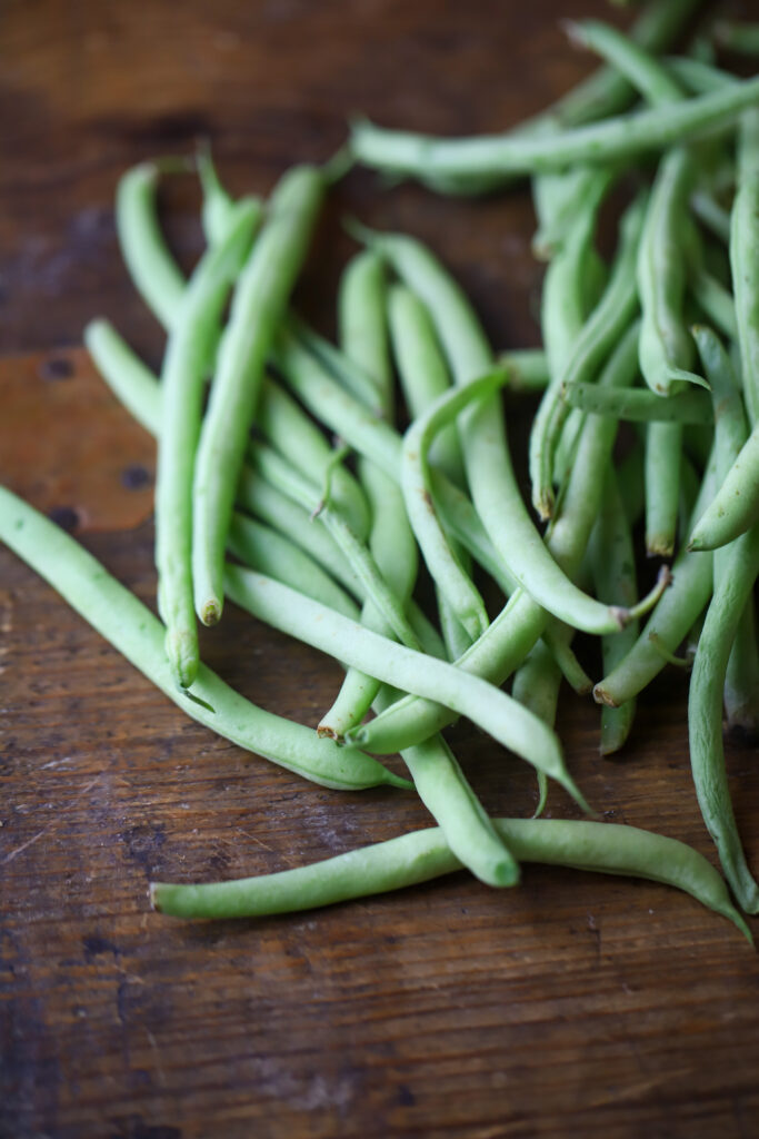 Ok y'all. These zesty Italian bacon wrapped green beans. Simplest, easiest and most delicious side veggie. You'll take some fresh green beans, make a little bundle, wrap them in bacon, then top with a few seasonings, brown sugar, and zesty Italian salad dressing. Bake and that's it. So simple and so delicious!