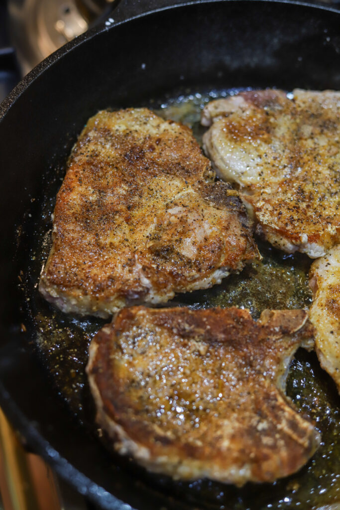 This one pot pork chop maque choux. Maque choux is a traditional, southern corn dish with peppers and ham or bacon. This one pot recipe combines it all with a pan fried, bone-in pork chop, on top a of corn, bell pepper, and bacon mixture. Add a cream of celery to give it a gravy feel then serve it all over rice or mashed potatoes. This recipe is so simple and perfect for dinner. 