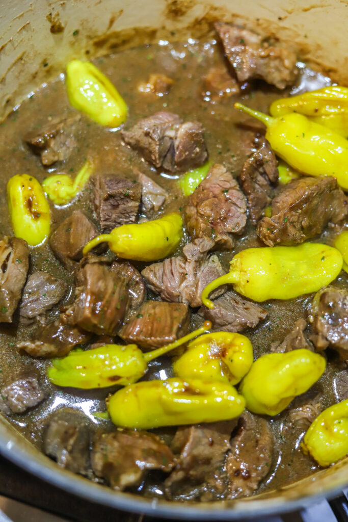 These Mississippi pot roast style beef tips are so tender and rich. These are just beef tips cooked like the popular Mississippi pot roast. It's butter, ranch seasonings, beef gravy, pepperoncini pepper all cooked together with some juicy beef tips. Buy cut beef tips in the store or buy a roast and cut into pieces like I did. Either way, this recipe is simple and delicious and takes less than an hour to make.