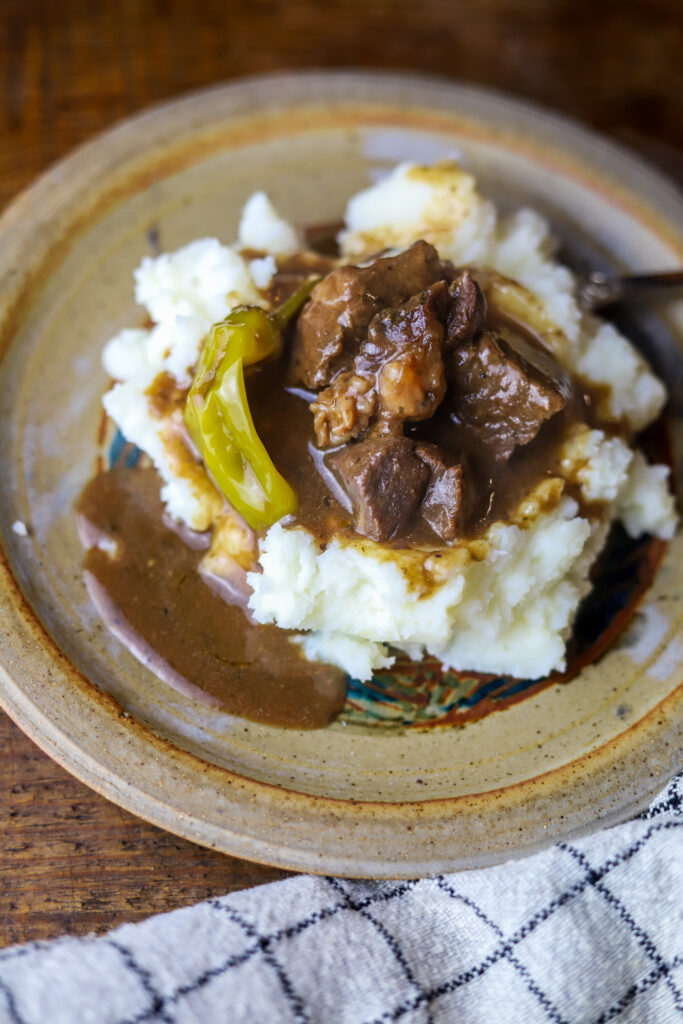 These Mississippi pot roast style beef tips are so tender and rich. These are just beef tips cooked like the popular Mississippi pot roast. It's butter, ranch seasonings, beef gravy, pepperoncini pepper all cooked together with some juicy beef tips. Buy cut beef tips in the store or buy a roast and cut into pieces like I did. Either way, this recipe is simple and delicious and takes less than an hour to make.