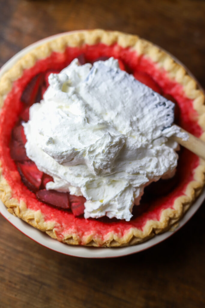 I love an old-fashioned strawberry pie. So this recipe has a twist on the Marie Callender's fresh strawberry pie. I had a pie crust and some fresh strawberries and decided to throw it all together. Once thing I do like about this recipe, is the strawberry part is not too sweet. If that's even possible? It pairs perfect with the flaky crust, and my personal favorite part, a thick layer of homemade whipped cream topping. Top it more fresh strawberries to finish it off. This pie just looks delicious. Read along to see how I made this simple strawberry pie in no time.