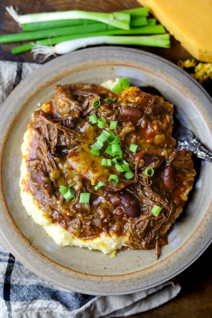 This chuck roast chili. Oh my gosh. This is the most comfortable food there is. It's a chuck roast slow cooked with chili seasonings, beans, and Rotel tomatoes. This chili has a savory and sweet flavor and you 100% have to serve it over creamy cheese grits. My crew loved this recipe. It's one of our new favorites.