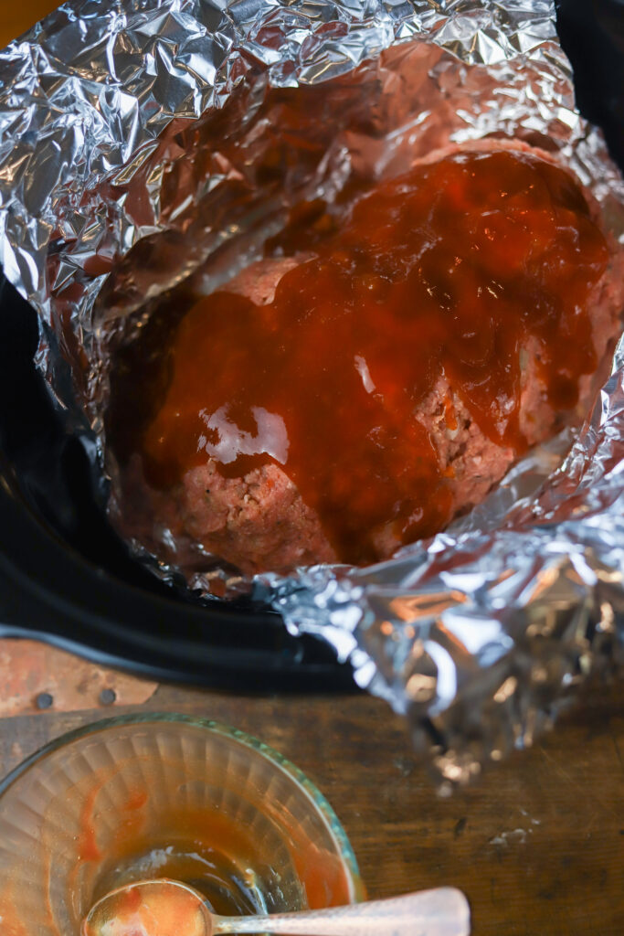 I love this easy crockpot meatloaf. This is nothing more than a traditional meatloaf recipe slow cooked all. You'll prepare the meatloaf just as you normally would, then line several sheets of foil in your slow cooker, place the loaf inside and slow cook on loaf for up to 6 hours. This recipe comes out so tender, juicy and delicious.