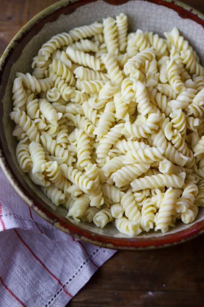 You'll love this Mexican street corn pasta salad. It's a mix of rotini pasta, two types of roasted corn, a can of Rotel tomatoes, Cotija cheese and a spicy dressing. This is such a fun, delicious and simple way to make pasta salad, and there are so many ways to serve it.