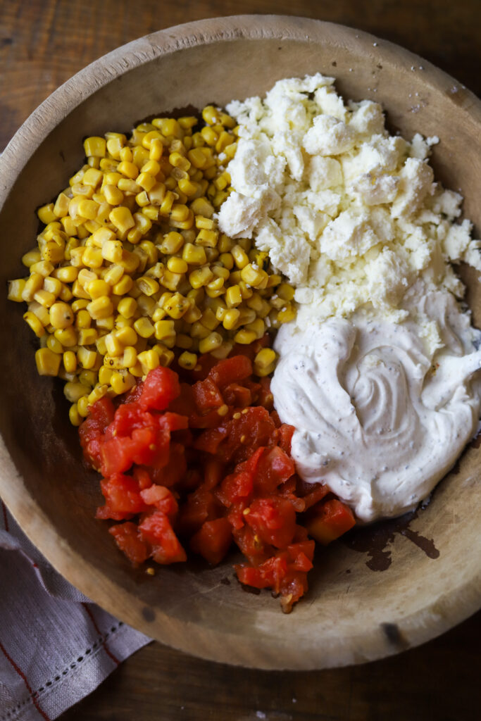 You'll love this Mexican street corn pasta salad. It's a mix of rotini pasta, two types of roasted corn, a can of Rotel tomatoes, Cotija cheese and a spicy dressing. This is such a fun, delicious and simple way to make pasta salad, and there are so many ways to serve it.