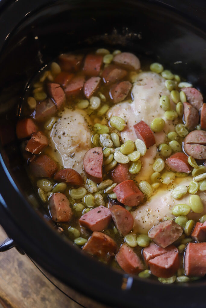 This crockpot smothered chicken with sausage and lima. Ok. This is really just a throw it all in the crockpot, easy, southern comfort dish. You'll slow cook some chicken, sausage and lima beans together all day, and right before serving, mix up a homemade gravy and pour it in. This is recipe is extremely easy and so delicious. 