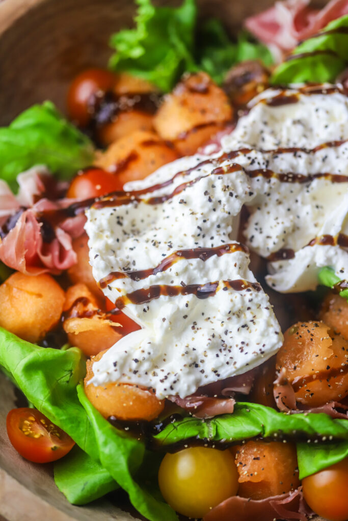 This summer cantaloupe salad with prosciutto and burrata. It's perfect for this time of year. I love a melon salad, and this one pairs perfect with the savory flavors of the prosciutto and creamy burrata cheese. Drizzle a balsamic and fresh cracked salt and pepper for the finishing touch. So good.