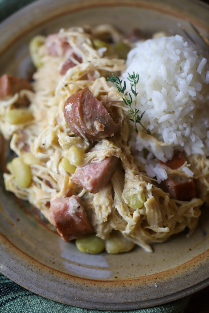 This crockpot smothered chicken with sausage and lima. Ok. This is really just a throw it all in the crockpot, easy, southern comfort dish. You'll slow cook some chicken, sausage and lima beans together all day, and right before serving, mix up a homemade gravy and pour it in. This is recipe is extremely easy and so delicious. 