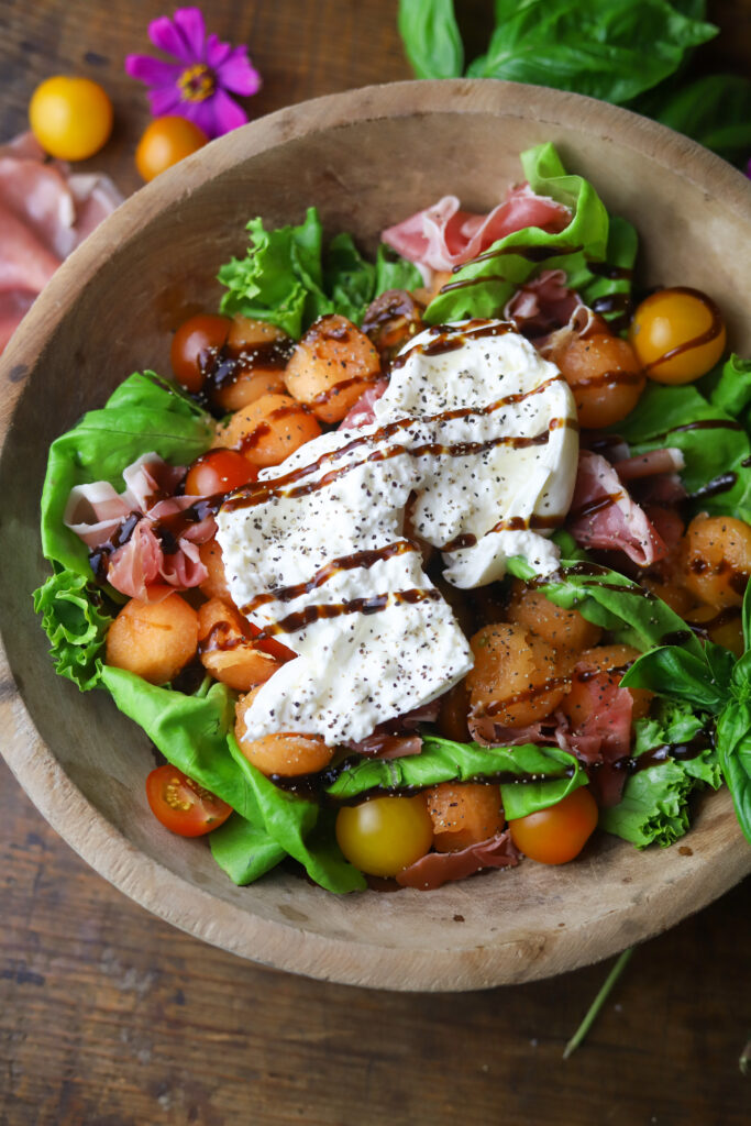 This summer cantaloupe salad with prosciutto and burrata. It's perfect for this time of year. I love a melon salad, and this one pairs perfect with the savory flavors of the prosciutto and creamy burrata cheese. Drizzle a balsamic and fresh cracked salt and pepper for the finishing touch. So good.