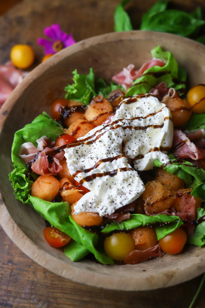 This summer cantaloupe salad with prosciutto and burrata. It's perfect for this time of year. I love a melon salad, and this one pairs perfect with the savory flavors of the prosciutto and creamy burrata cheese. Drizzle a balsamic and fresh cracked salt and pepper for the finishing touch. So good.