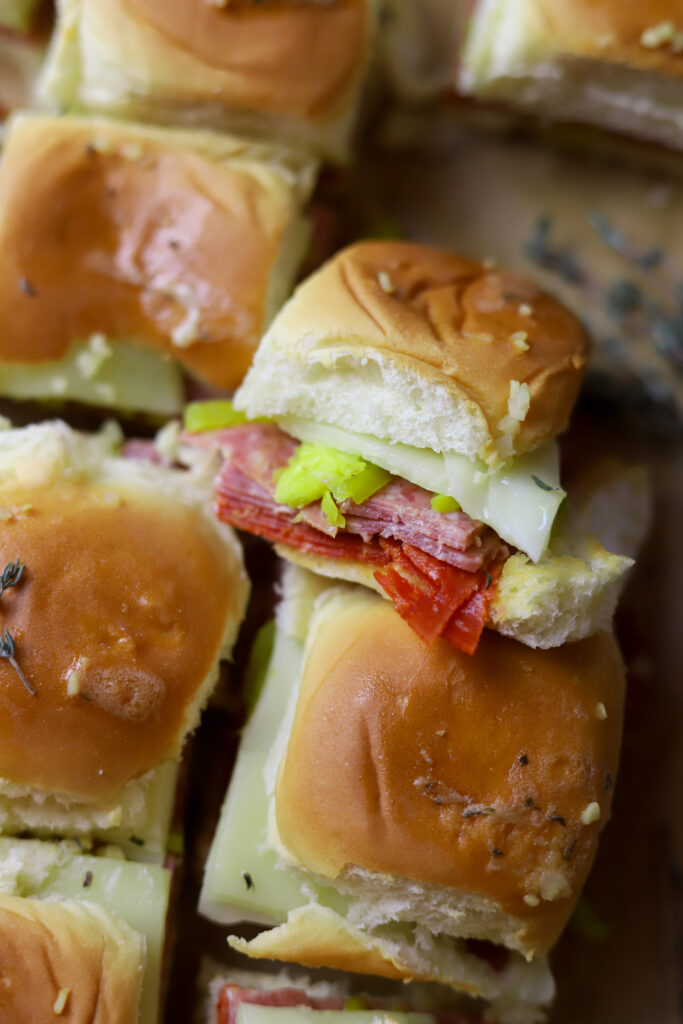 I love this hot Italian sliders recipe. You can make a meal out of these or make them as an appetizer. These are simple. They’re just pepperoni, salami, provolone and banana peppers in some Hawaiian rolls. You’ll love these; I promise.