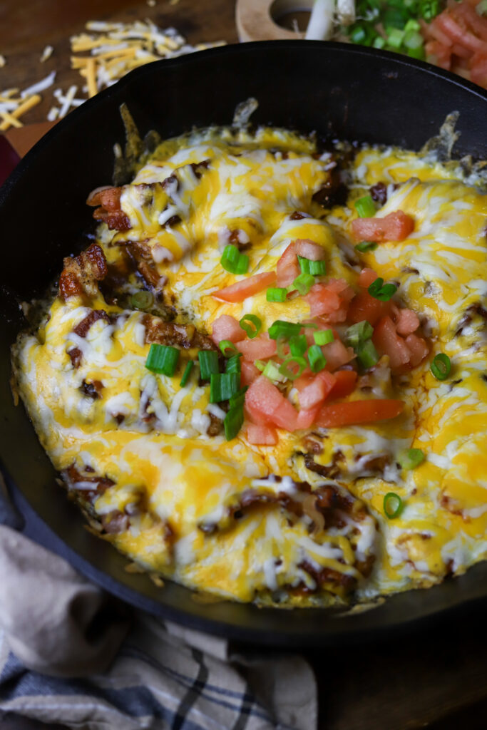 This Monterey chicken skillet is a perfect dinner idea. It's a pan-fried chicken breast, smothered in barbeque sauce, baked and them topped with a blend of cheese and bacon. This is really taking a simple chicken breast and kicking it up a notch. This easy dinner is something different that's packed with flavor.